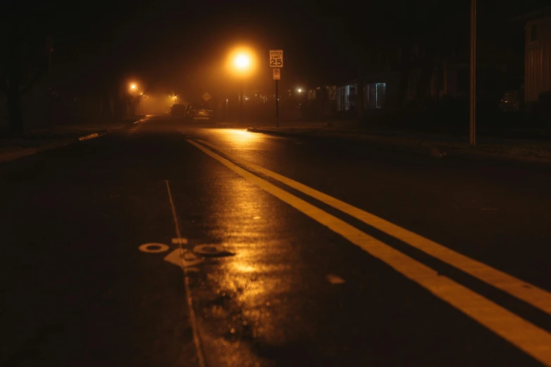 a street filled with rain and a night time po