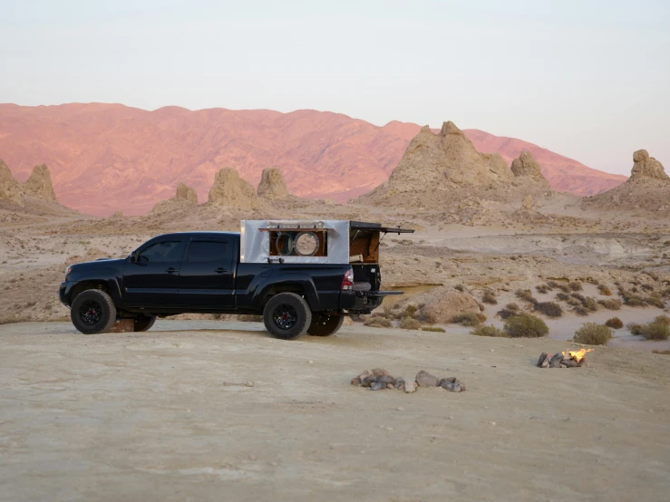 a truck is sitting in the middle of the desert