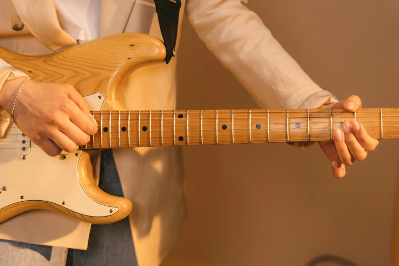 a person playing an electric guitar while holding it