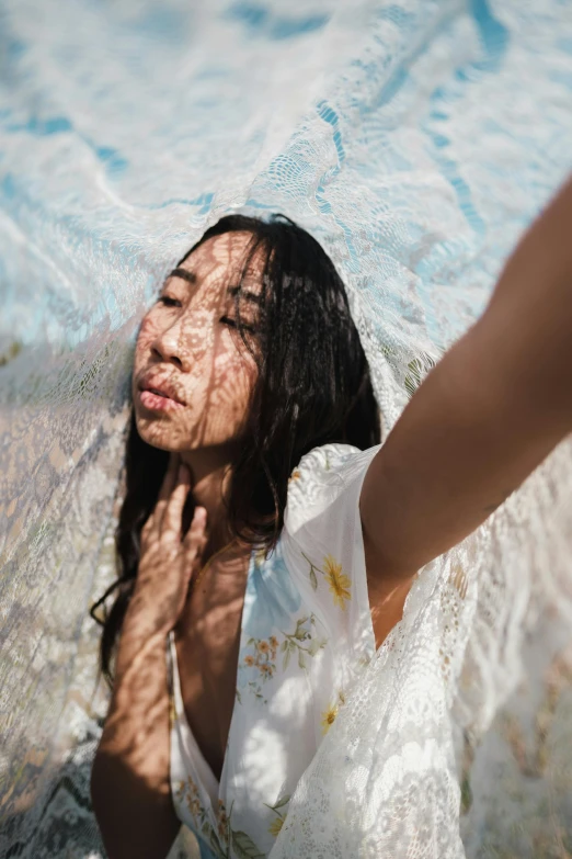 a young lady with black hair is standing in the water