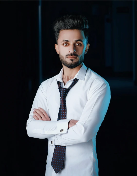 a man with a beard and wearing a white shirt and tie