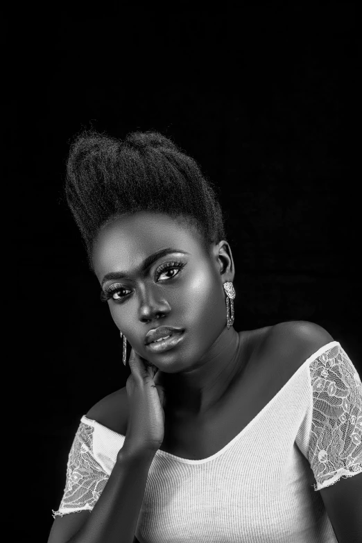 a black and white po of a woman wearing a shirt and earring