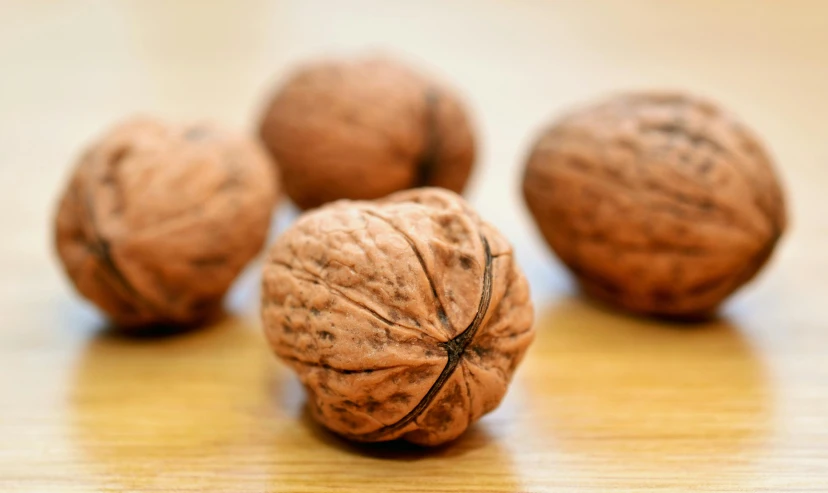 a group of nuts sitting on top of a wooden table