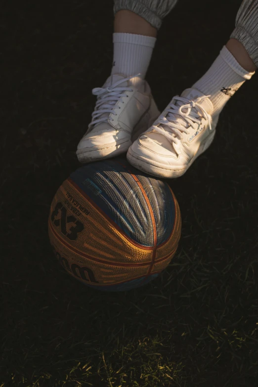 person standing on top of a basketball with a sock on