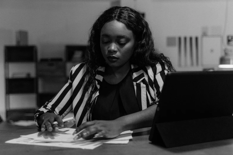 a young woman working on a laptop in an office