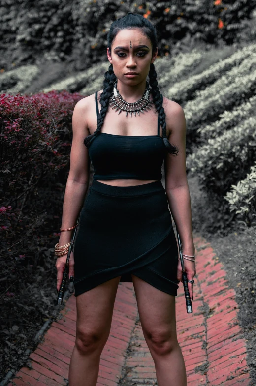 a beautiful young woman in a black dress posing