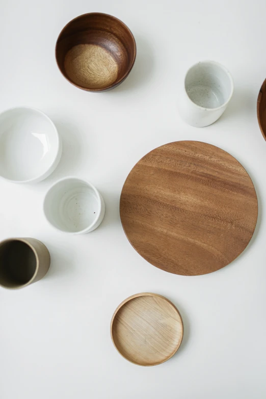 a wooden plate surrounded by bowls and spoons