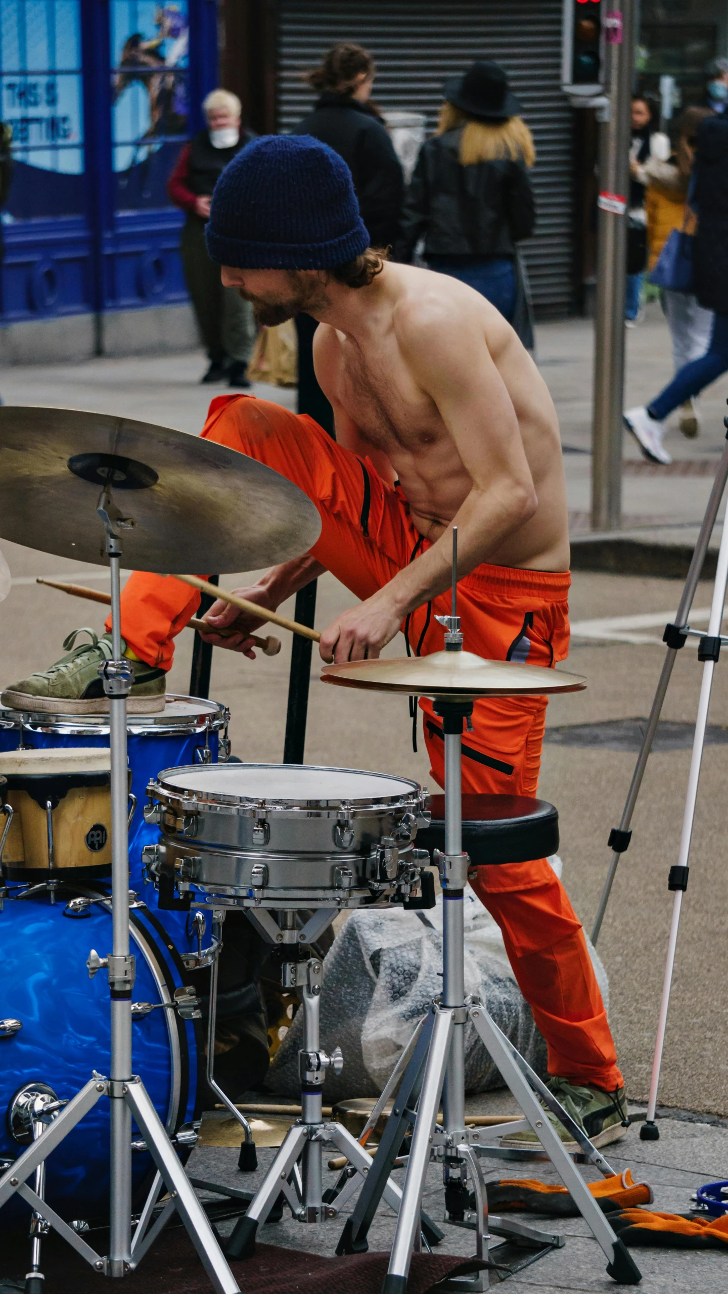 a man that is sitting in front of a drum set