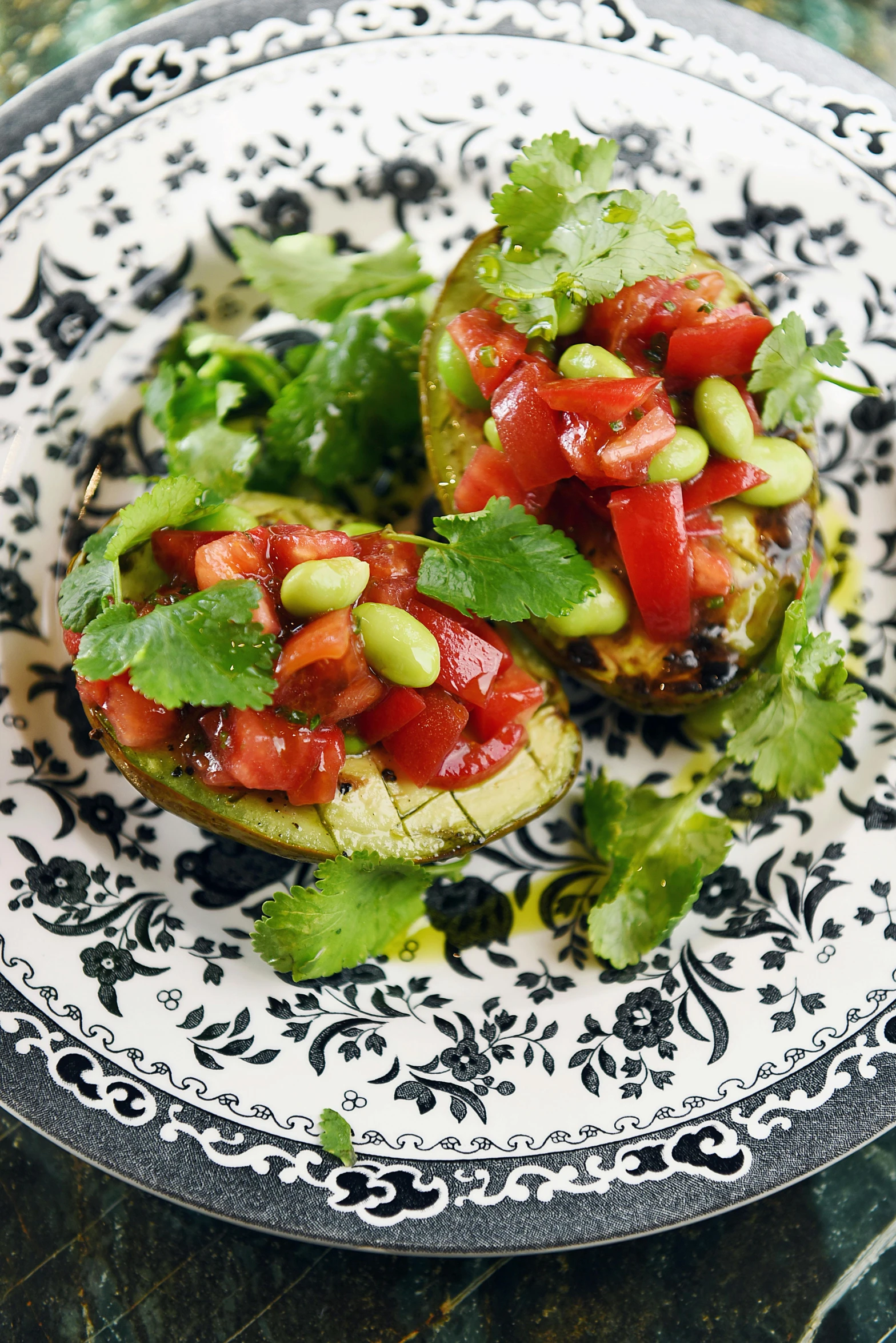 two open faced stuffed avocados with toppings on top of each