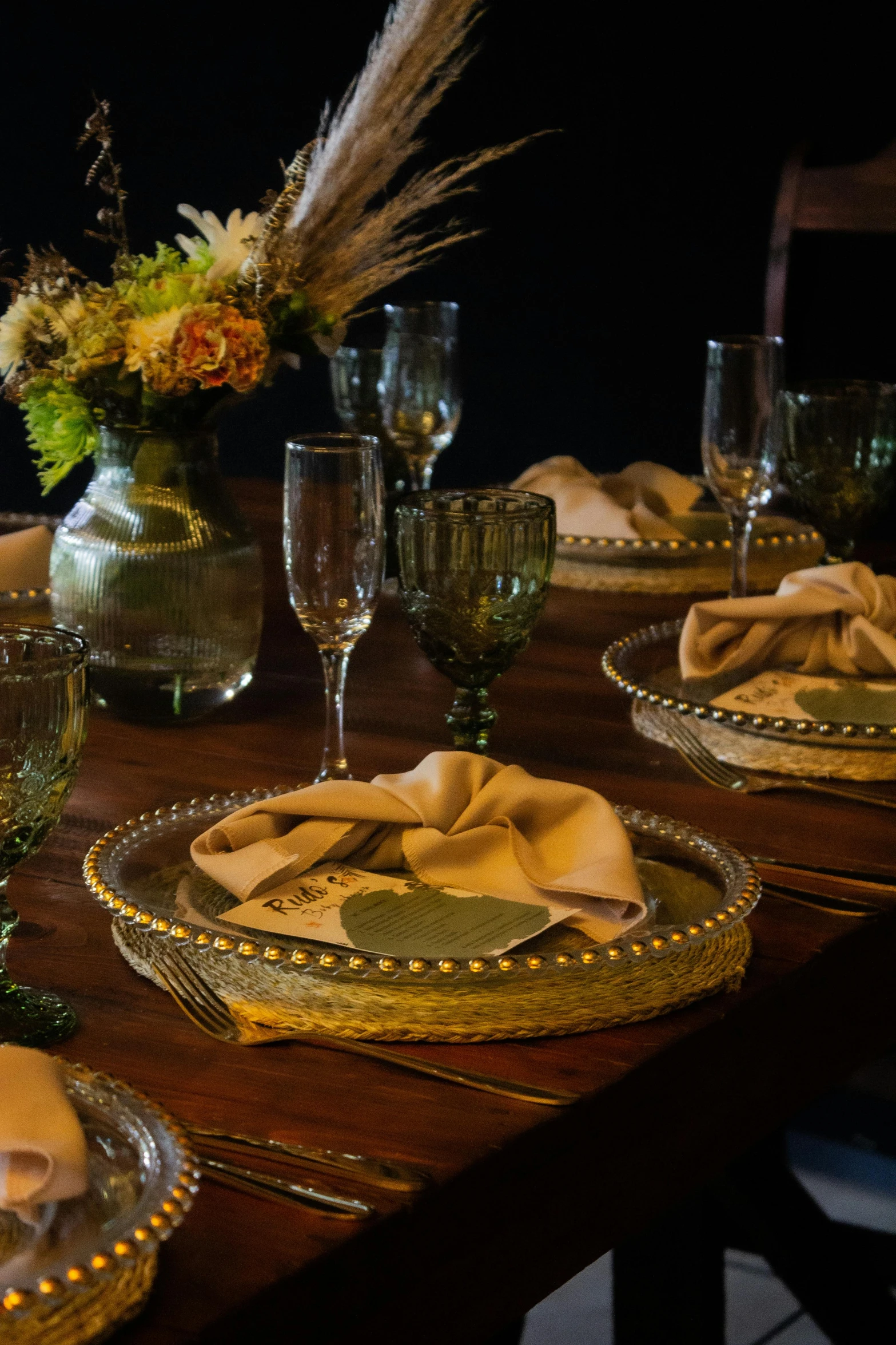 a table is set for four with a centerpiece and place settings