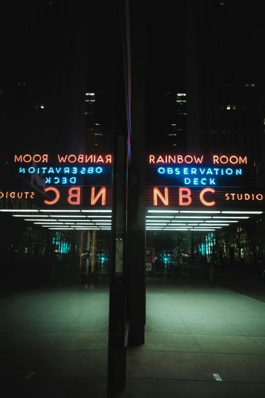 illuminated street sign and lights at night time