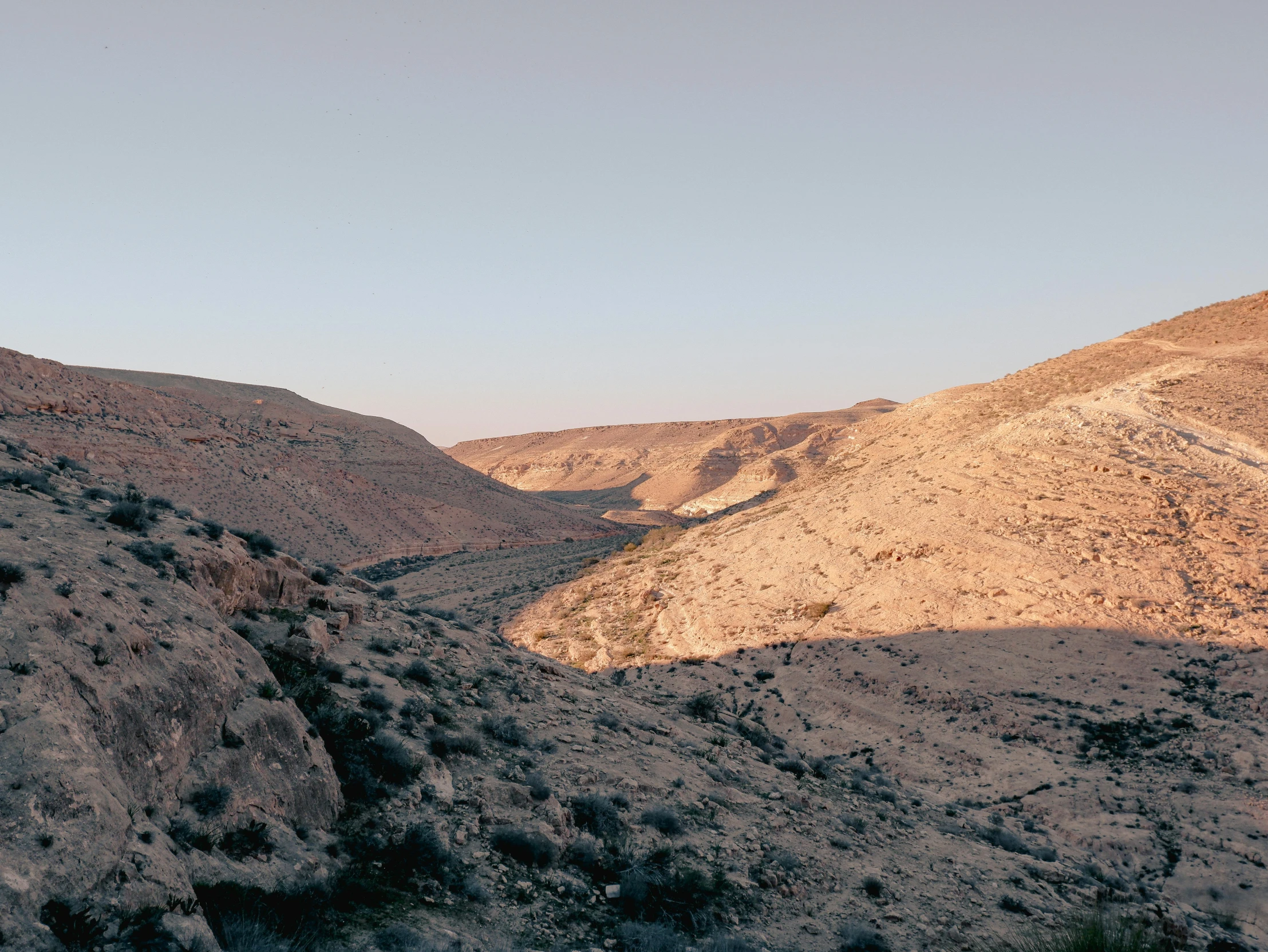 a hill view with a small stream in the center