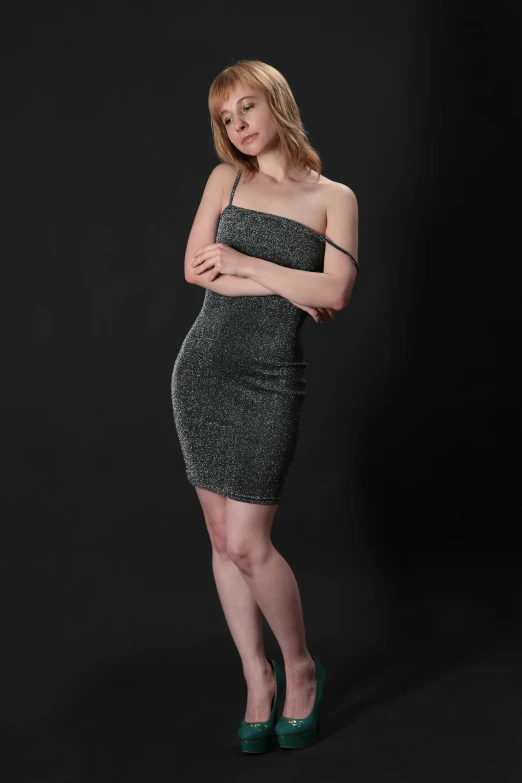 a beautiful woman posing in a short black dress