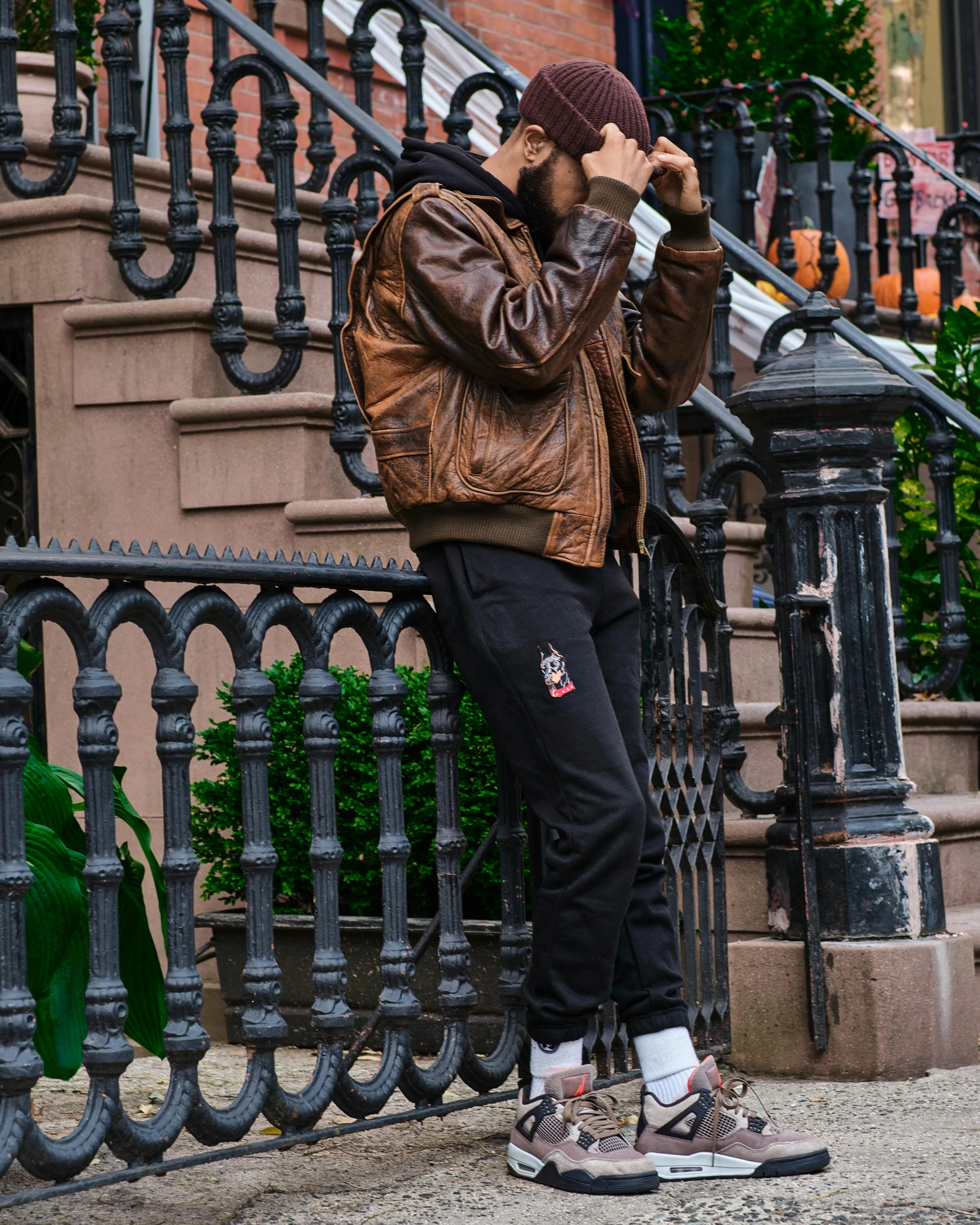 a man on a cell phone and wearing a jacket