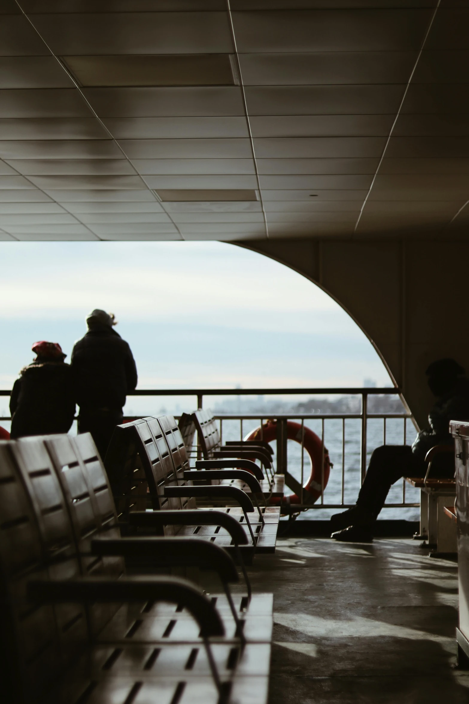 a group of people sitting on top of a ferry boat