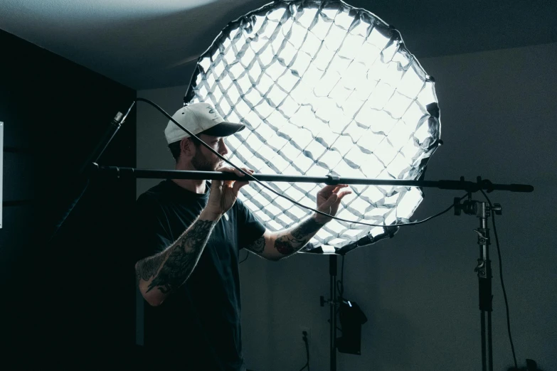 a man stands holding a light in his hand