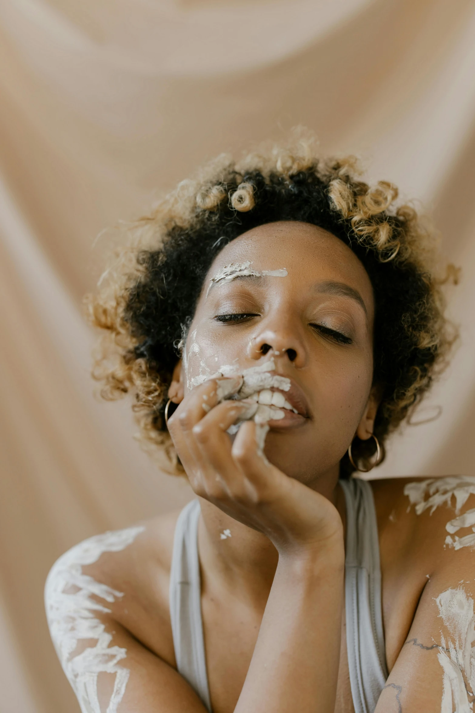 a woman covered with white powder in a pose