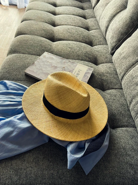 a brown hat on a cloth covered couch