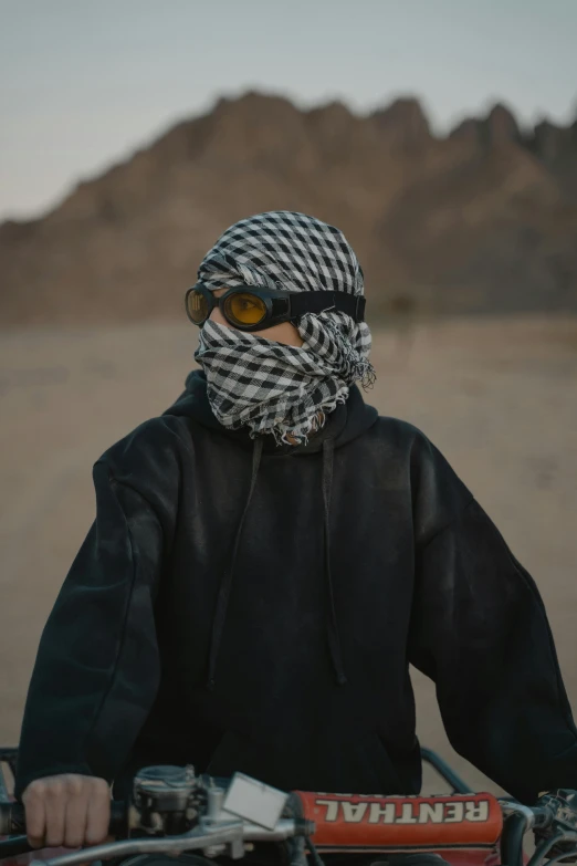 a person wearing a scarf on top of a bike