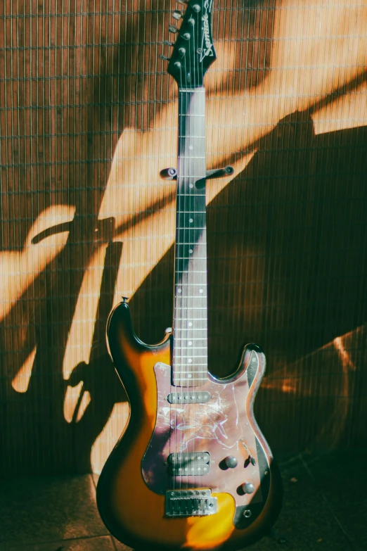 a yellow guitar sitting on top of a shelf