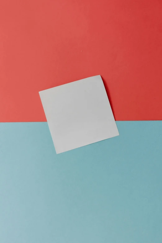 a small piece of white paper with two different color swatches on it