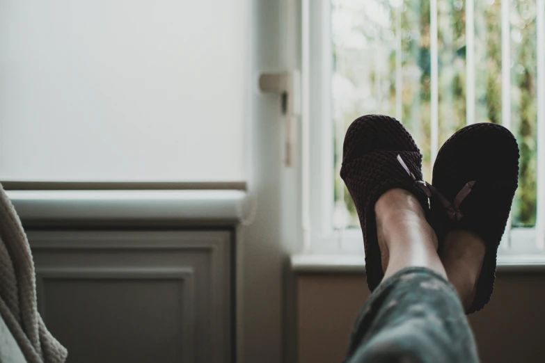 the feet and soles of a woman standing in front of a window