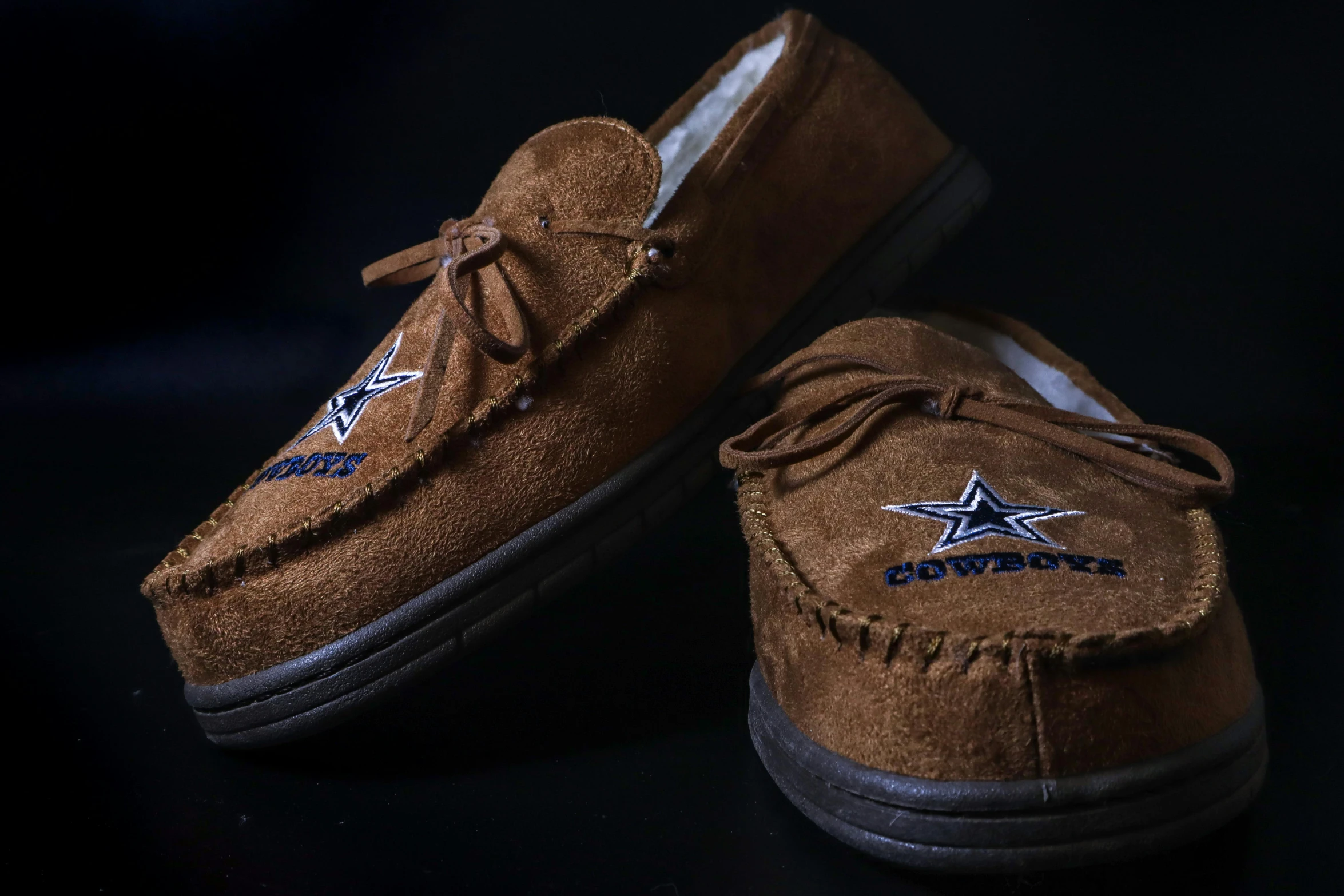 the brown suede shoes are all new with converse on them