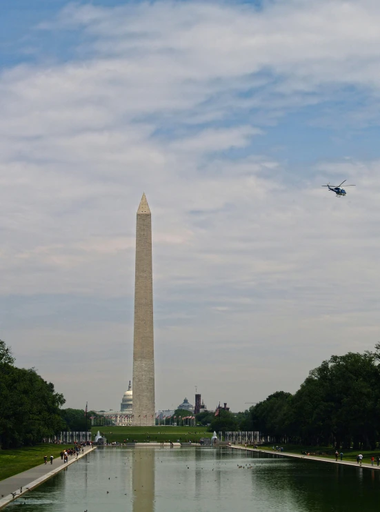 the washington monument as a plane flies past