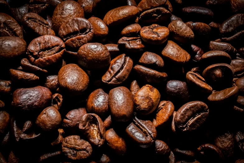 roasted coffee beans and walnuts are shown