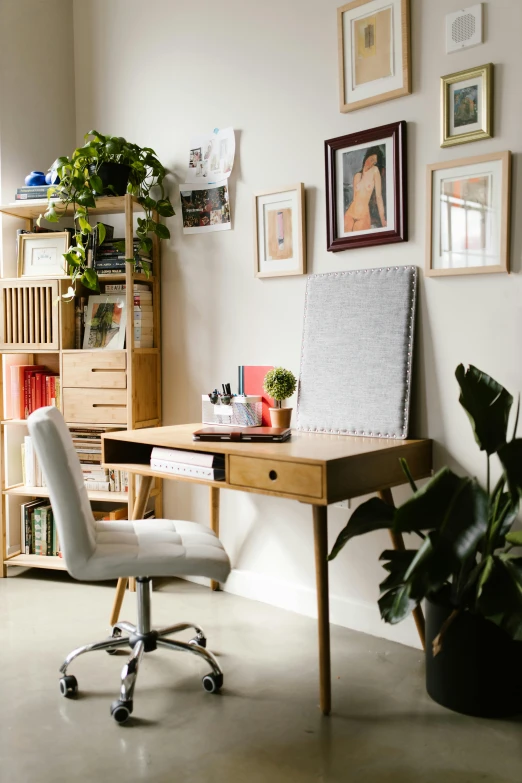 a home office with lots of pictures on the wall