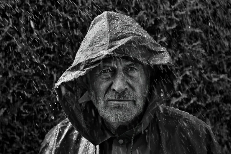 man with a hat and coat in the rain