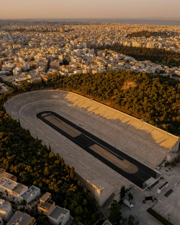 an aerial view of a stadium in a large area of town