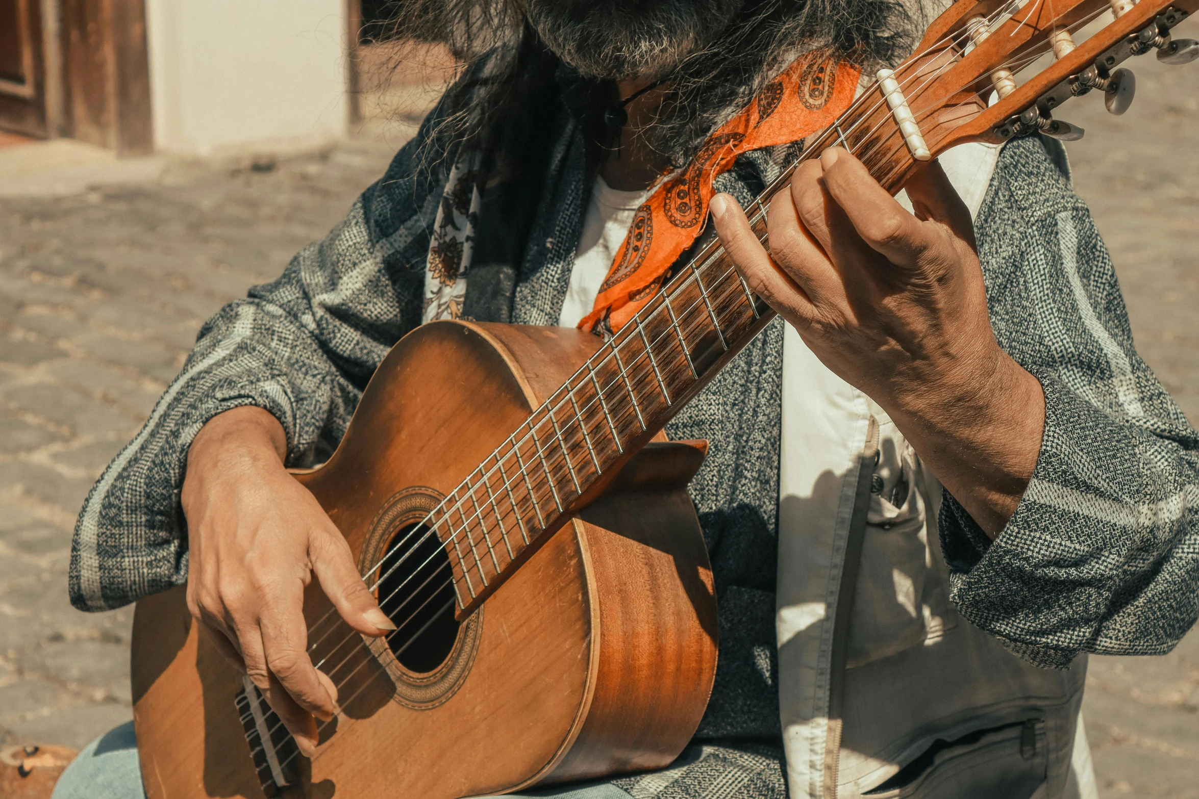 a man holding an orange guitar in his hands