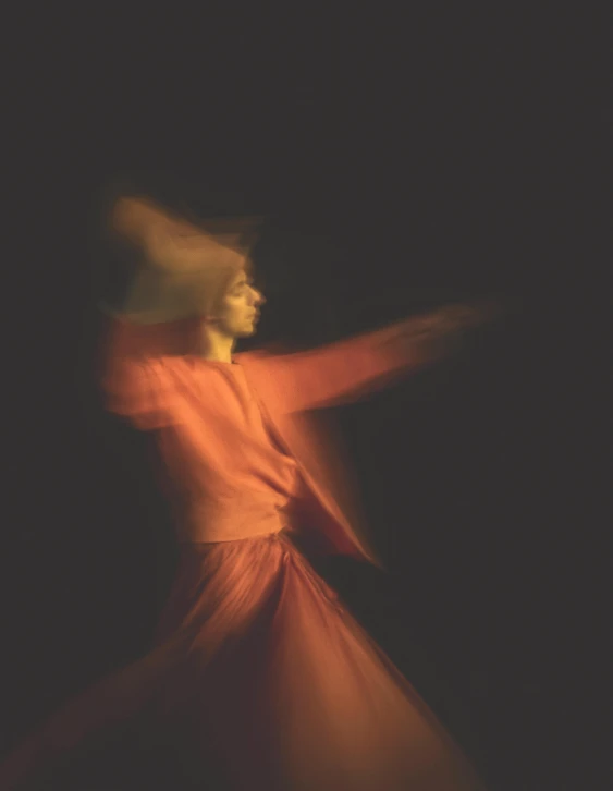 a woman is dancing on stage with a hat on