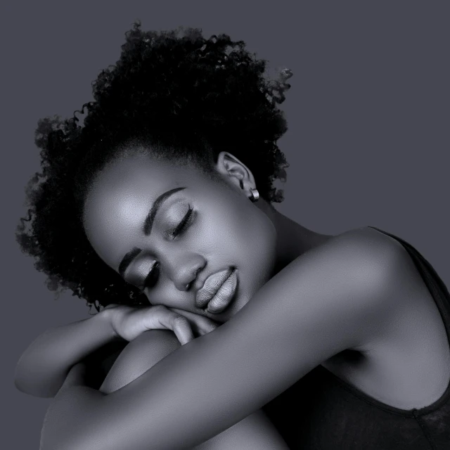 an african woman poses with her arms resting on her head