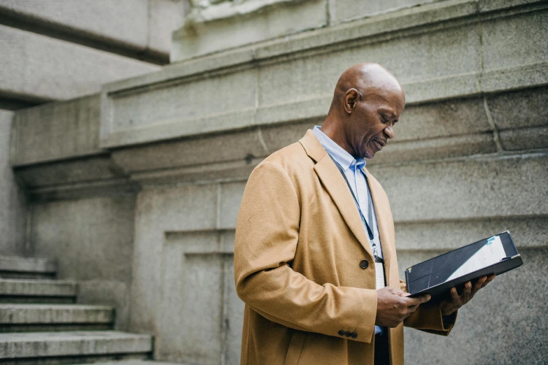 a man that is standing up with a book