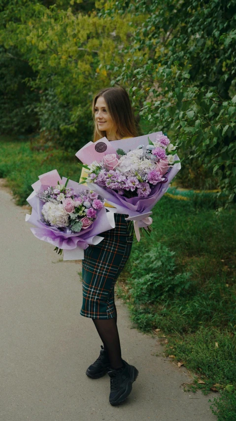 a young woman with some flowers on the road