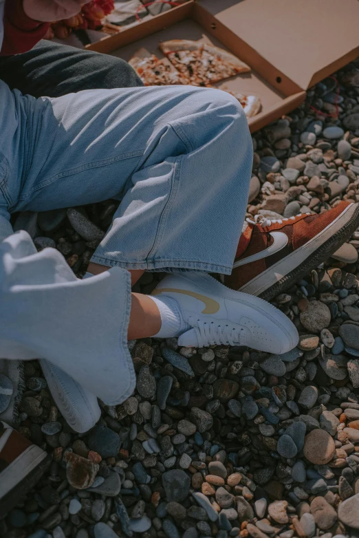 a person in white gloves is on the pebbles