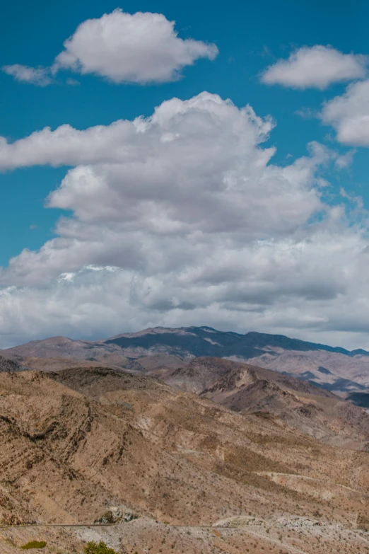 a beautiful mountain scene has clouds above it