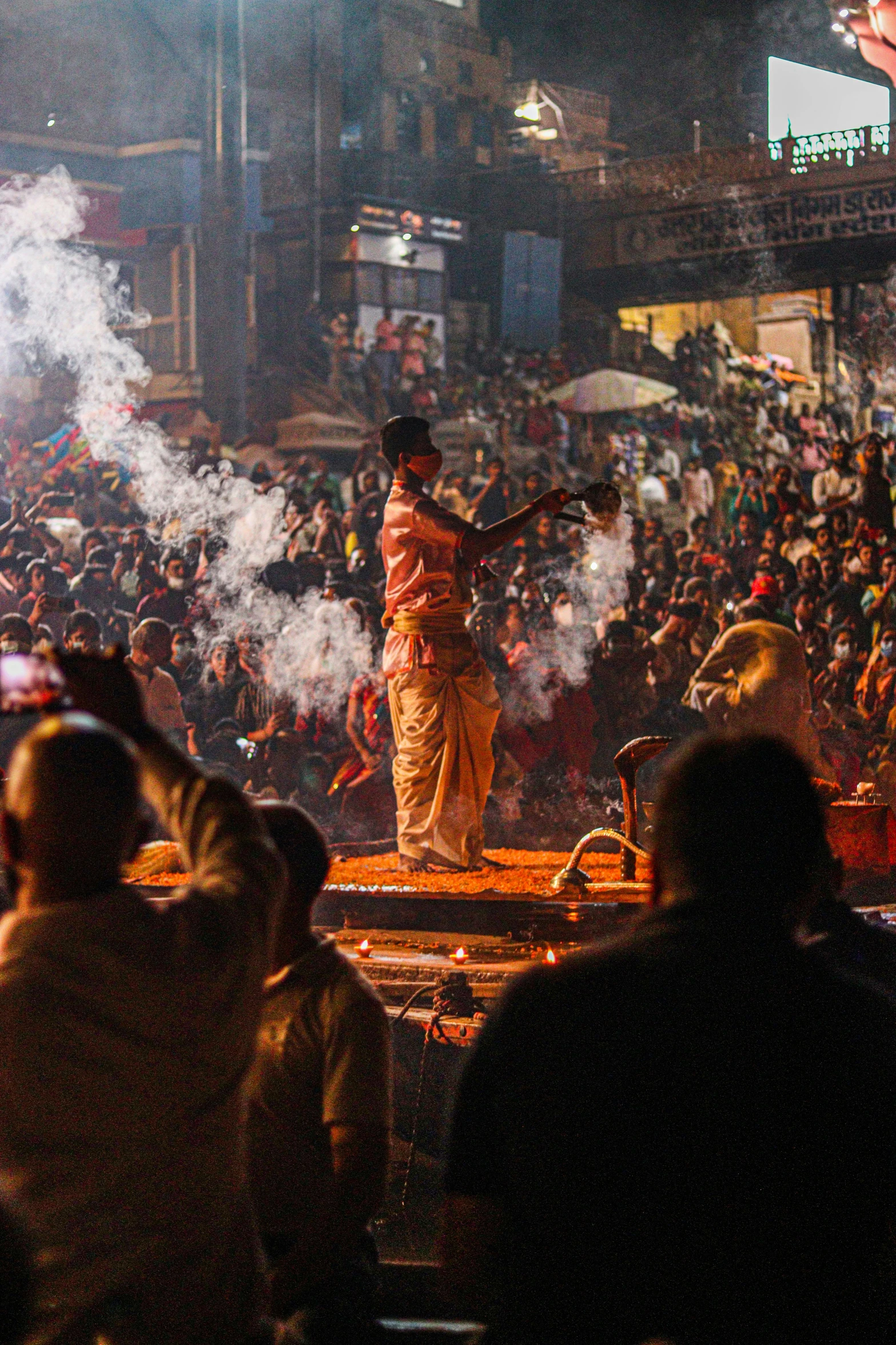 a man standing on top of a stage next to a crowd