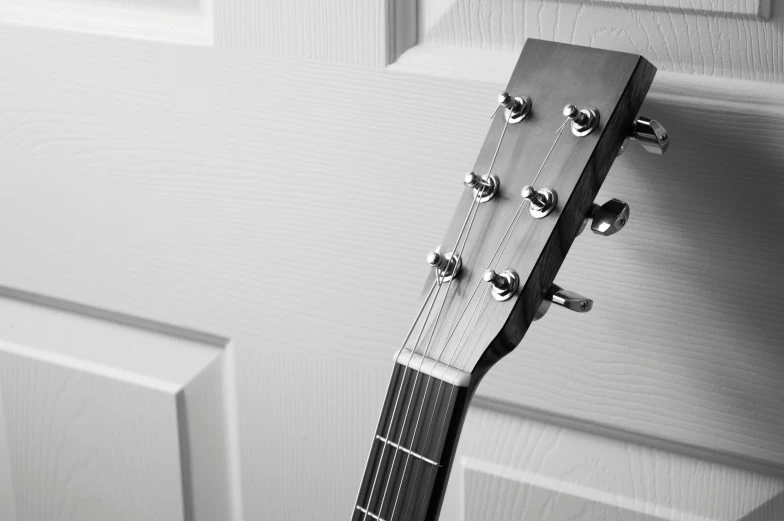 a guitar hanging on the wall by itself