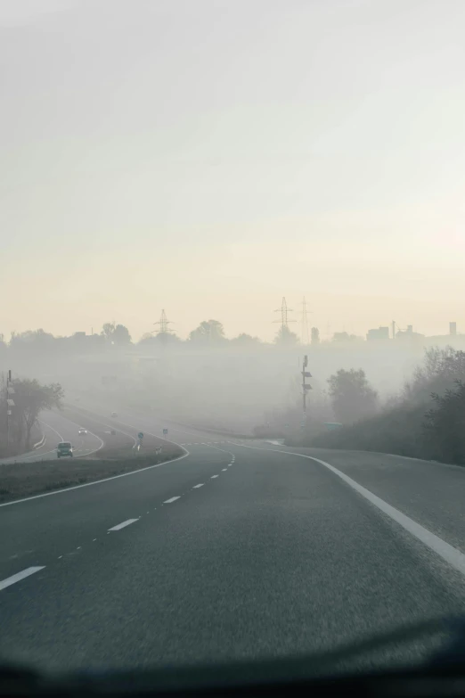 an empty street near an area with fog