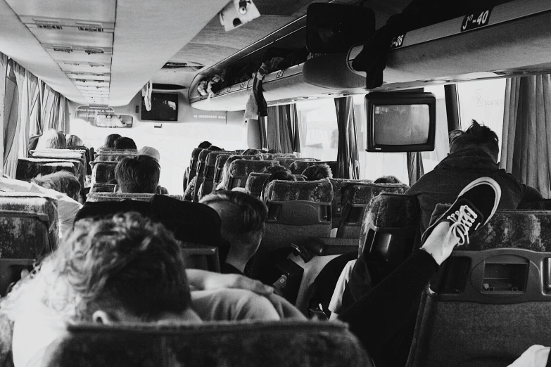 a bus full of people with a tv on