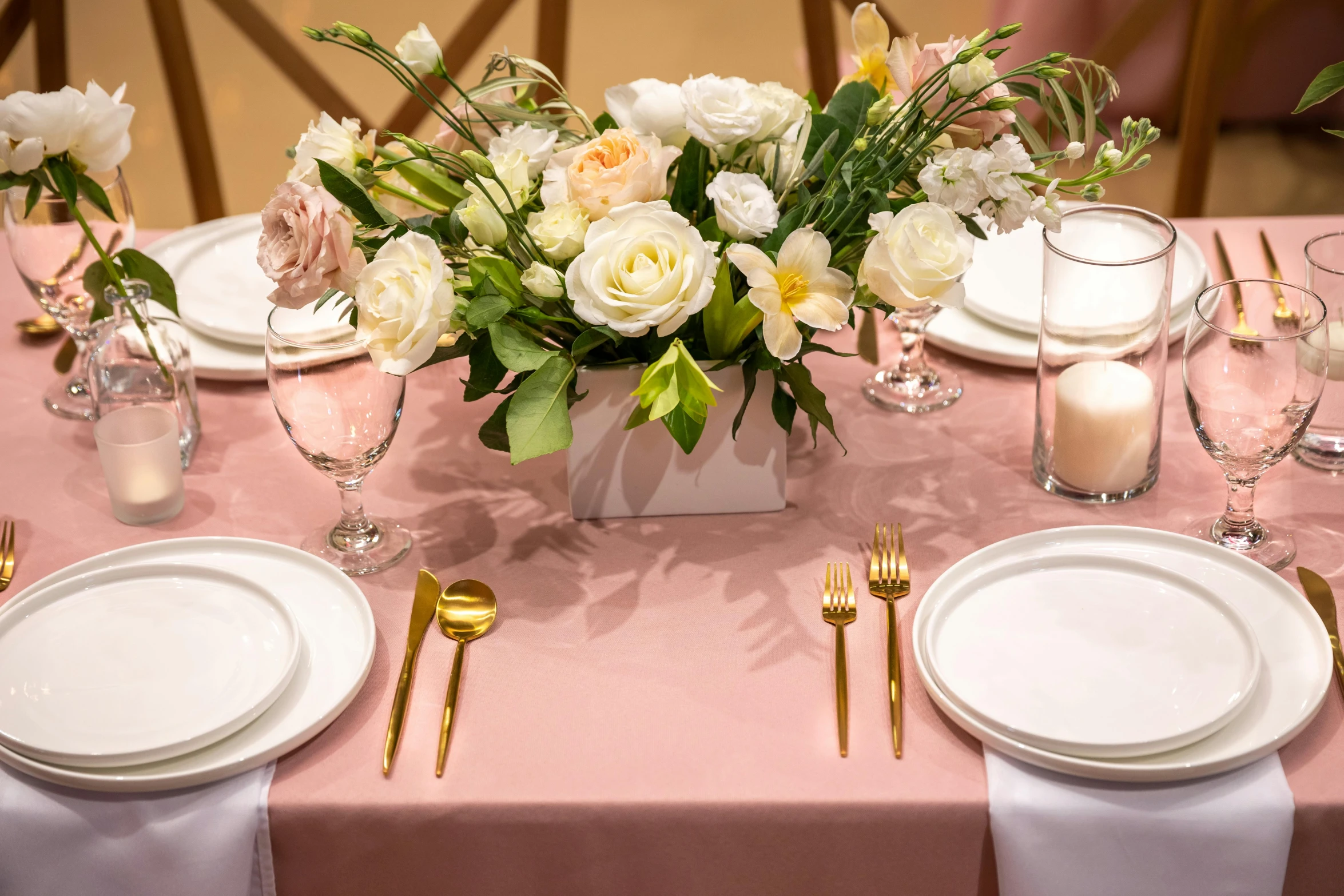 a center piece on a table covered with napkins and flowers