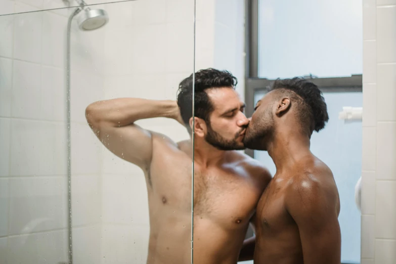 two muscular men are in front of a mirror