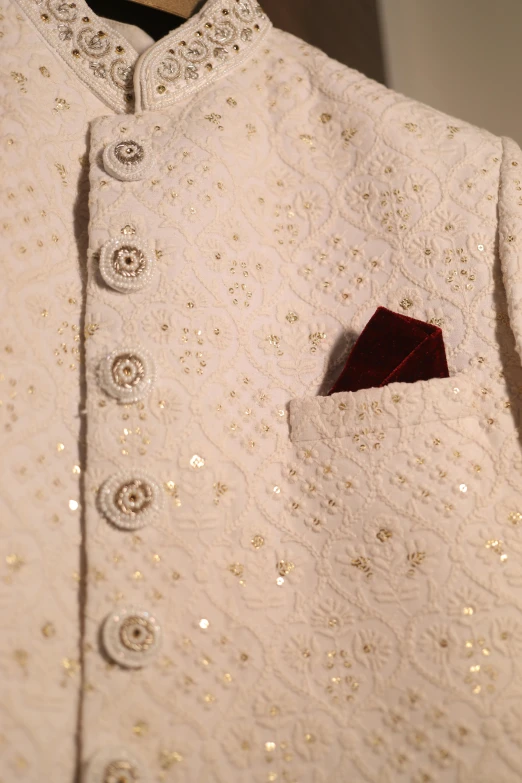 an embroidered jacket with ons is being displayed
