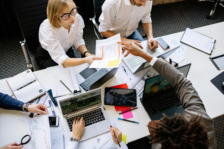 people doing work in a group working on various things