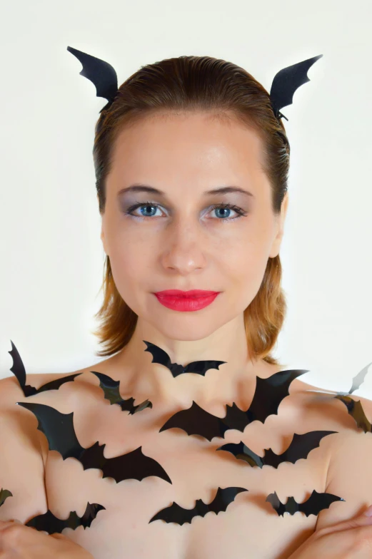 a woman wearing black bat wings while posing