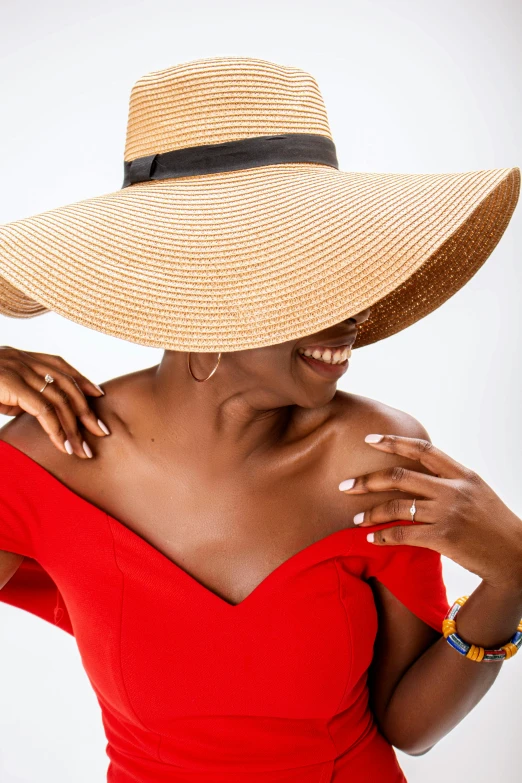 a woman in a red dress with a straw hat