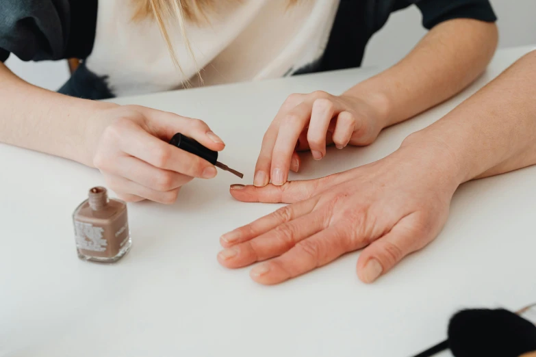 someone's hands holding on to a nail varnish